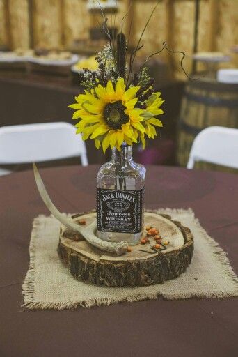 Whiskey Bottle centerpiece   Rustic Wedding Decor Whiskey Bottle Centerpiece, Country Thanksgiving Decorations, Sunflower Themed Wedding, Bottle Centerpieces, Rock Wedding, Mom Wedding, Western Wedding, Sunflower Wedding, Wedding Table Centerpieces