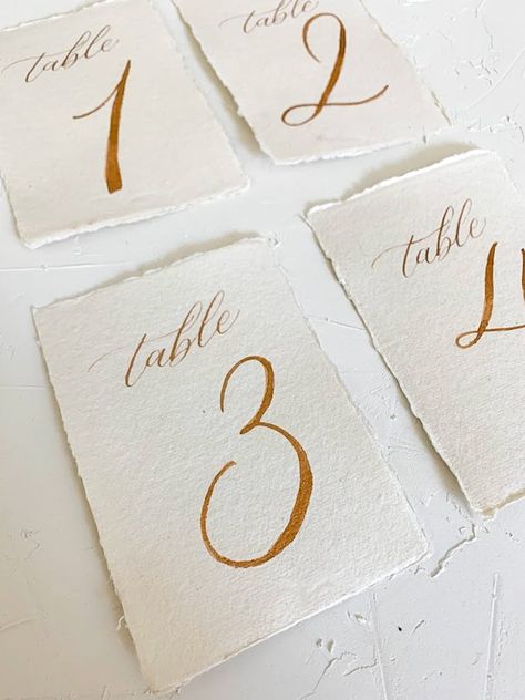 Reception Aesthetic, Gold Wedding Table Numbers, Elegant Table Numbers, Wedding Invitation Details Card, Classic Wedding Reception, Calligraphy Table Numbers, Vintage Italian Wedding, Letters Calligraphy, Gold Table Numbers Wedding