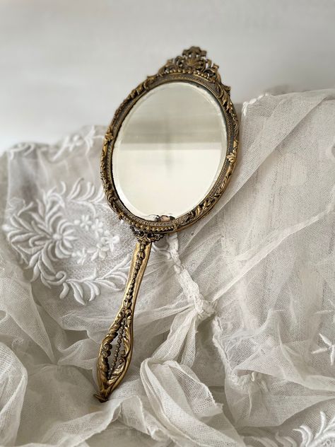 A beautiful antique French hand mirror from the Palais Royal district in Paris, known for incredible craftsmanship. Lovely intricate detailing. Please see all photos as these form part of description. Slightly foxed mirror, very pretty. Black reverse. Dimensions to follow Ancient Mirror Aesthetic, Vintage Hand Mirror Aesthetic, Aesthetic Hand Mirror, Royal Mirror Aesthetic, Hand Mirror Aesthetic, Royality Aesthetics, Gold Mirror Aesthetic, Vintage Mirror Aesthetic, Old Hand Mirror