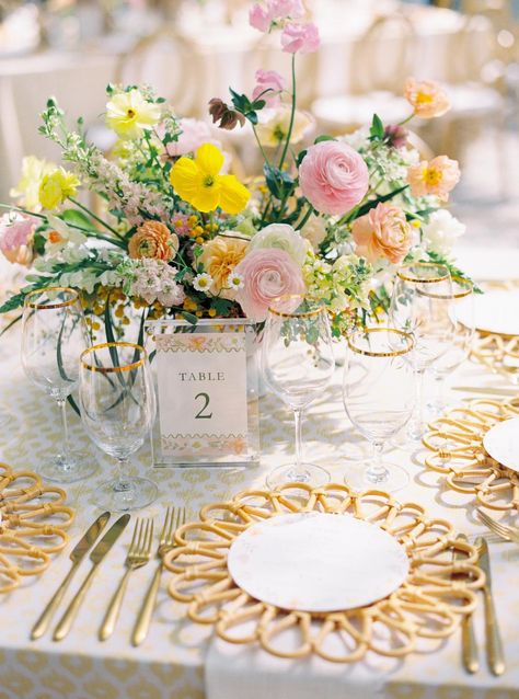 A vibrant tablescape featuring colorful florals, gold-rimmed glassware, and unique woven chargers—perfect for a cheerful and elegant reception. For more tablescape ideas, visit Style Me Pretty. 🌼  Photography: Kailee DiMeglio Photography (http://www.kaileedimeglio.com) Yellow Wedding Reception, Vibrant Tablescape, Kiawah Wedding, Pink And Yellow Wedding, Whimsical Garden Party, Woven Charger, Rehearsal Dinner Decorations, Pretty Photography, Colorful Florals