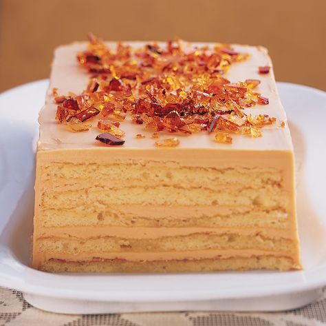 A rich Dobos Torte -- which has alternating layers of yellow genoise cake and Caramel Buttercream -- is topped with coarsely chopped caramelized sugar. The original recipe was created in 1887 by the Hungarian chef whose name it bears. Dessert Recipes With Caramel, Recipes With Caramel, Dobos Torte Recipe, Dobos Torte, Genoise Cake, Christmas Dessert Recipes, Torte Recipe, Caramel Buttercream, Stroopwafel