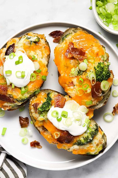 These Broccoli Cheddar Twice Baked Potatoes are the epitome of comfort food! They are also super easy to make, and can be made ahead of time! A salty, slightly crisp potato skin is filled with creamy luxurious mashed potatoes mixed with fresh broccoli, sharp cheddar cheese, and crumbled bacon. Top with sour cream and sliced green onion for good measure and dinner is done! Broccoli Stuffed Potatoes, Broccoli And Cheese Twice Baked Potatoes, Twice Baked Broccoli Cheese Potatoes, Potato Skins Easy, Brocolli Cheddar Potato, Brocolli Cheddar Baked Potato, Vegetarian Bacon, Coconut Bacon, Smoked Gouda Cheese