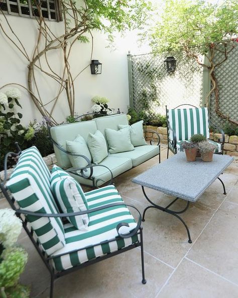 Warner House on Instagram: "As the days get lighter and brighter, we’re dreaming of Spring mornings drinking coffee alfresco in @amelialiana’s courtyard oasis. Outdoor furniture upholstered in our HOLKHAM Spruce stripe and BLAKENEY Sage outdoor fabrics. #warnerhouse1870" Green Garden Furniture, Courtyard Oasis, Outdoor Fabrics, Outside Living, Backyard Retreat, Blue House, Striped Fabrics, Garden Room, Outdoor Fabric