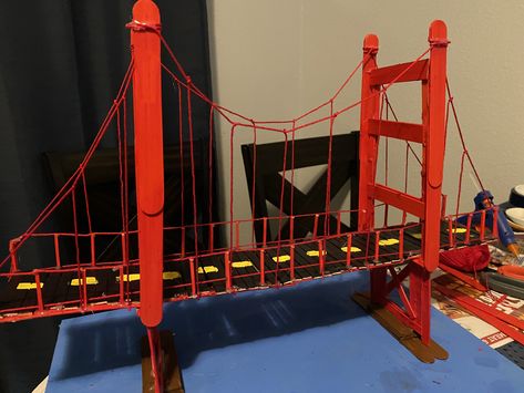 My daughters 4th grade project. We used popsicle sticks, hot glue gun, yarn, and red paint Treasure School, Popsicle Bridge, Stem Bridges, Popsicle Stick Bridges, Popsicle House, Science Exhibition Projects, Bridge Ideas, Bridge Project, Science Exhibition