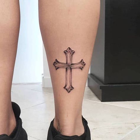 silhouette of a cross tattooed on the back of the leg of woman wearing black sneakers tattoos that mean strength Cross On Leg Tattoo, Cross Leg Tattoo, Louise Tattoo, T1d Tattoo, Cool Cross Tattoos, Cross Tattoo Ideas, Unique Cross Tattoos, Tato Geometris, Small Cross Tattoos