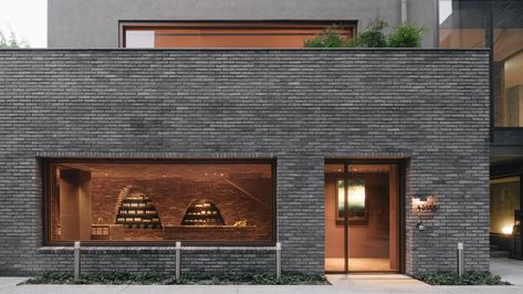 Mlkk Studio used reclaimed red bricks to fashion the snug interiors of this Aesop store, which lies behind the intimidating dark-grey facade of a building in Seoul. Grey Brick Houses, Aesop Store, Small Lounge, Grey Brick, Black Brick, Brick Architecture, Brick Facade, Brick Building, Shop Interiors