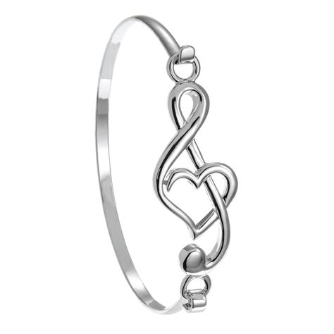 PRICES MAY VARY. Stylish and Elegant -- Music note bracelet will make a stunning musical statement and special treat for you or a favorite music lover, music teacher or musician friend Classy Style -- Treble clef bracelet with heart and hook closure comes in a PammyJ gift box with a protective sleeve, great for gift giving Sizing -- Music bracelet measures 2 ¼ inches and will fit up to a 7 inch wrist Gift For Musician -- for women, girl, or teen musician for their birthday or celebration of an a Treble Clef Heart, Music Note Bracelet, Music Bracelet, Twist Jewelry, Gift For Musician, Heart Bangle Bracelet, Wire Wrap Jewelry Designs, Womens Bangles, Musical Jewelry