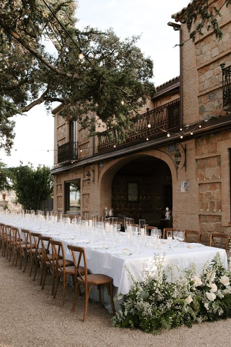 In a Spanish venue that was already breathtaking, the Spain wedding table setups took the aesthetic to a whole new level. From the choice of linen to the floral arrangements, every detail was aligned with the destination wedding aesthetic Madison and Brandon wanted. Dive deeper into the details on our blog. Breathtaking Wedding Venues, California Spanish Style Wedding, Black Tie Tuscan Wedding, Europe Wedding Aesthetic, Spanish Modern Wedding, Spanish Hacienda Wedding, Spain Wedding Theme, Spanish Wedding Aesthetic, Spanish Style Wedding Reception