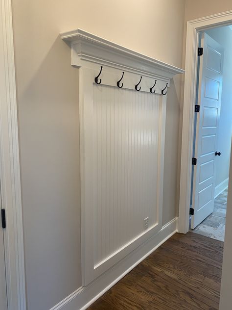 Mirror Above Doorway, Wainscoting Entryway Hooks, Wall Over Stairs Decor, Wainscoting With Coat Hooks, Hallway Beadboard, Shiplap Coat Rack Wall, Built In Coat Rack Entryway, Entry Way Wainscotting With Hooks, Board And Batten Entry Wall With Hooks