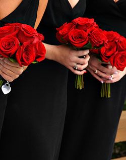 Black dresses, red bouquets! Red Bouquet Wedding Bridesmaid, Simple Rose Bridesmaid Bouquet, Red Bridal Bouquet Rose, Red Bridesmaids Bouquets, Black Bridesmaid Dresses With Red Roses, Simple Red Rose Bridal Bouquet, Black And White Wedding With Red Roses, Bridesmaid Rose Bouquet, Simple Red Rose Bouquet