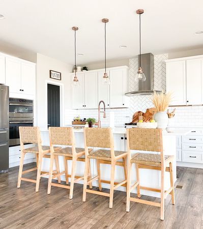 Have you been looking for the perfect boho bar stools for your kitchen island? Click the link to see my round up of all the best and budget friendly boho bar stools from Target, World Market and Walmart! These would also work well with farmhouse style! They are all neutral and perfect with all kitchen styles and colors! #whitekitchen #whitecabinets #whitecounters #subwaytile #whitesubwaytile #subwaytilebacksplash #copperkitchen #copperaccents #blackdoor #diningroom #kitchen Boho Bar Stools, Boho Coffee Bar, Island Bar Stools, Woven Bar Stools, Boho Bar, Rattan Counter Stools, Rattan Bar Stools, Kitchen Styles, Bar Stools Kitchen Island