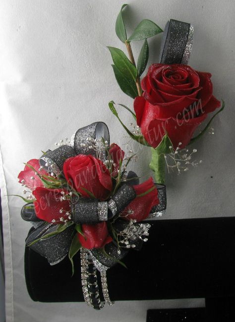 Deep Red Roses with silver and black ribbon.  The bracelet is rhinestones and in 3 parts.  2 Clear Rhinestone bands and one black.  $47.00 Red And Black Prom Corsage, Black And Red Prom Flowers, Red Black Corsage, Red And Black Prom Bouquet, Red Black And Silver Corsage, Boutonniere Corsage, Bracelet Corsage, Deep Red Roses, Prom Flowers Corsage