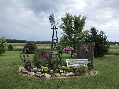 Small Windmill Yard Decor, Decorative Yard Windmills, Landscaping Around Windmill, Rustic Flower Beds In Front Of House Country Decor, Front Yard Landscaping Rustic, Landscaping With Old Farm Equipment, Milk Can Landscaping Ideas, Front Yard Landscaping Country, Yard Windmill Garden Art