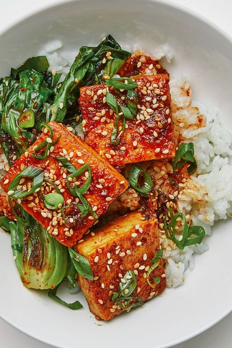 “I never think twice about stocking up on a few packages of firm tofu,” says Christina Chaey. “On the night when I don’t want to spend more than 20 minutes on dinner, I whip up this riff on dubu jorim, a popular Korean side dish, and call it dinner. I pan-fry thick tofu slices in a skillet until golden, then quickly braise them in a salty-sweet-spicy soy sauce mixture until they’re steeped with flavor, ready for a simple side of rice and sautéed greens.” Braised Tofu Recipe, Braised Tofu, Bar Restaurant Design, Vegan Kimchi, Cooking Tofu, Sauteed Greens, Korean Side Dishes, Mapo Tofu, Firm Tofu