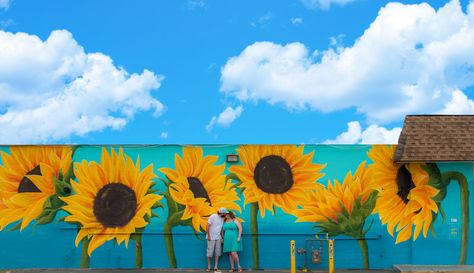 "The happy mural project" painted this beautiful wall in St. Pete Florida. Outdoor Wall Art Front Of House, Sunflower Mural Wall Art, Painted Fences Mural, Sunflower Mural, House Mural, Wood House Design, Exterior Murals, St Pete Florida, Garden Fence Art