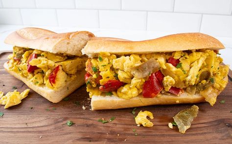 The Pepper & Egg Sandwich is a savory delight featuring whisked eggs, sautéed sweet peppers, onions, and fresh parsley, all nestled in an hoagie roll. Seasoned with fine sea salt and ground black pepper, this recipe offers a quick and tasty option for breakfast or brunch. Easy to make and sure to satisfy your taste buds! Eggs In Peppers, Hoagie Rolls, Egg Sandwiches, Fresh Parsley, Stuffed Sweet Peppers, Breakfast Brunch, Sandwiches, Rolls, Stuffed Peppers