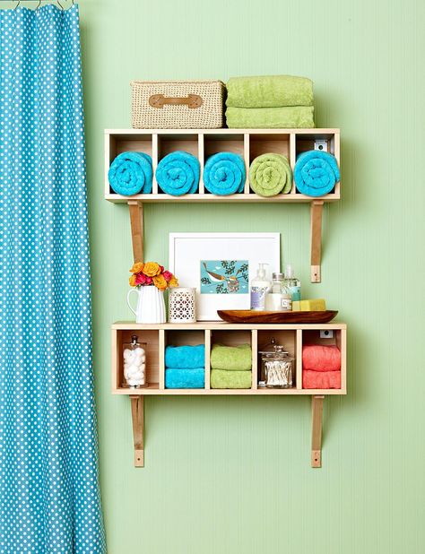 Shelves are far less costly to install than drawers and cupboards. When outfitted with cubby-style openings, they offer compartmentalized storage and easy accessibility. #declutter #organizing #organizeyourbathroom #declutteryourbathroom #bathroomideas #bhg Bathroom Wall Organization, Shelves Over Tub, Bathroom Shelves Over Tub, Colorful Small Bathroom, Small Bathroom Wallpaper, Small Space Hacks, Small Bathroom Colors, Small Bathroom Tiles, Budget Plan