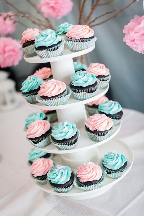 Cupcake towerChocolate cupcakes with blue and pink frosting. Pink And Blue Food Ideas, Gender Reveal Cupcake Ideas Pink Blue, Blue And Pink Desserts, Gender Reveal Cake And Cupcakes, Pink And Blue Cupcakes Gender Reveal, Pink And Blue Baby Shower Cake, Cupcake Gender Reveal Ideas, Gender Reveal Cupcakes Pink And Blue, Gender Reveal Dessert Table Ideas