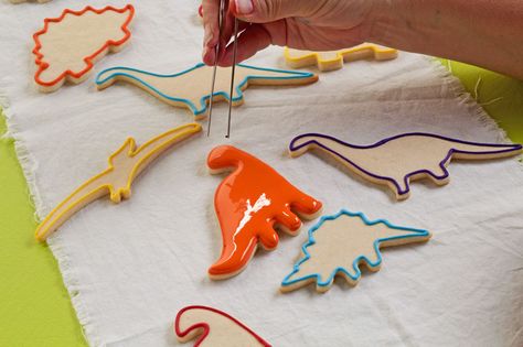 Simple Dinosaur Cookies -Sugar Cookies Decorated with Royal Icing | The Bearfoot Baker    #bearfootbaker #edibleart #rolloutcookies #royalicing #airbrushedcookies #decoratedcookies #sugarcookies #dinosaurcookies #cookiesforboys #funcookies #dinosaur #cutecookies #dinocookies #dino Dinosaur Cookie, Cookies Decorated With Royal Icing, Cookie Birthday Party, Dinosaur Cookies, Sugar Cookie Royal Icing, Halloween Birthday Party, Cookie Tutorials, Easy Sugar Cookies, Royal Icing Decorations