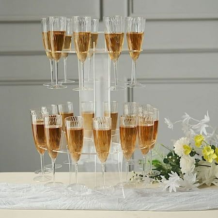 Entertain in style at your next gathering with this elegant standing champagne glass holder. Ideal as wine glasses storage at home or beverage server for your parties and celebrations. This acrylic stand is designed with round plates to hold 23 champagne glasses and a top plate to hold your wine bottle. A great way to display and organize your party drinks. Place it on top of your drinks table and pair it with your garlands, flowers and balloons to create a refreshing atmosphere for your party s Champagne Display Table, Champagne Flute Stand, Champagne Glass Holder, Flute Stand, Round Table Sizes, Drink Display, Drink Stand, Bridal Theme, Wine Glass Rack