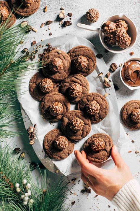 These hazelnut blossoms are a unique take on classic peanut butter blossoms! Nutella cookies are baked and topped with a hazelnut truffle. They're soft, sweet, crunchy, and so fun to make. #blossomcookies #nutellacookies #nutella #hazelnut #butternutbakery | butterrnutbakeryblog.com Butternut Bakery, Nutella Cookie, Butter Blossoms, Chewy Gingerbread Cookies, Monster Cookies Recipe, Soft Gingerbread Cookies, Blossom Cookies, Peanut Butter Blossoms, Chewy Sugar Cookies