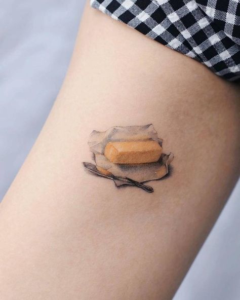 Micro-realistic butter tattoo on inner arm Butter Tattoo, Unusual Tattoos, Small Compass Tattoo, Small Tattoo Placement, Tato Minimal, Palm Mehndi Design, Tattoo Apprenticeship, Food Tattoos, Single Needle Tattoo