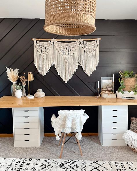 Simple boho touches create stunning ideas for office desk decor. Dried flowers, woven baskets, and wooden beads adorn the wooden counter on dual white storage units. A macrame wall hanging complements the boho theme. Boho Desk Aesthetic, Boho Theme Office, White And Wood Desk, Boho Western Office, Modern Boho Office, Boho Office Room, Room Ideas Aesthetic Summer, Modern Desk Decor, Boho Vanity