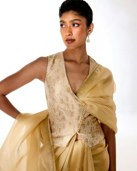 Old-world grandeur, combined with modern-day effortlessness. The light gold Triveni saree perfectly complements our delicately rose-patterned meenakari brocade blouse, crafted in a contemporary waistcoat style silhouette. Jewelry courtesy: @thehouseofrose #Tilfi #TilfiSarees #TilfiIcons Waistcoat Saree Blouse, Gold Saree Blouse, Waistcoat Style, Silhouette Jewelry, Kurti Styles, Floral Saree, Brocade Blouse, Brocade Blouses, Gold Blouse