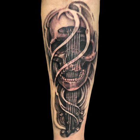 Super rad custom black and grey skull tattoo with a guitar neck on the forearm done by jordyn grine at evolved body art in Columbus Ohio #musictattoos #music #art #skull #skulltattoos #blackandgreytattoo #tattooideas #tattoo #breedloveguitars #guitar #customtattoo #columbus #ohio #evolvedbodyart Guitar And Skull Tattoo, Guitar Skull Tattoo, Music Skull Tattoo, Tattoos For Women Skull, Drummer Tattoo, Guitar Tattoos, Small Friendship Tattoos, Creepy Sketches, Small Colorful Tattoos