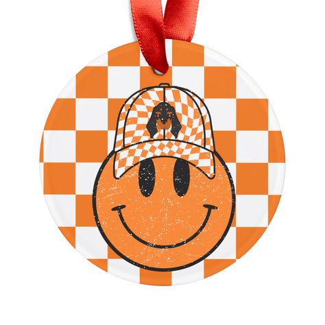 Great Tennessee Vols Christmas decoration! Touch up your home this holiday season with this Smiley Face "Tennessee Vols" inspired holiday ornament.  Each ornament comes with its own festive ribbon for easy placement, and is made 100% with acrylic material for beautiful decorations that last.  .: Material: 100% white acrylic .: Glossy finish .: All over print .: Includes red ribbon for hanging Ornament With Ribbon, Tennessee Vols, Tennessee Football, Beautiful Decorations, Tennessee Volunteers, Holiday Ornament, White Acrylic, White Acrylics, Acrylic Material