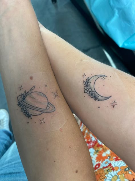 taylor swift moon and saturn tattoos from seven on folklore :) Seven Folklore Tattoo, Saturn Tattoo Aesthetic, Noon And Saturn Tattoo, Saturn Floral Tattoo, Sun Moon Saturn Tattoo, Saturn Flower Tattoo, Folklore Taylor Swift Inspired Tattoo, Floral Saturn Tattoo, Moon And Saturn Matching Tattoo