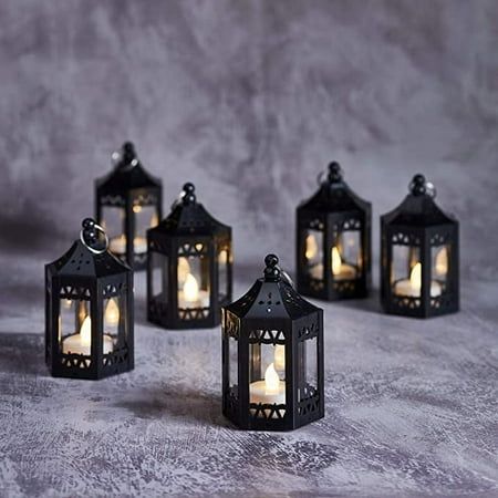 This set of black tea light candle lanterns will add a touch of Moroccan style wherever they are displayed and are a popular choice for weddings or Ramadan celebrations. Each lantern is illuminated by one warm white LED tea light candle which flickers gently and casts a cosy glow. Standing at 4.5 tall, they are perfect for mantels and tabletops, or use the handy hooks to hang them high. Made from plastic there's no need to worry about glass breakages and the LED bulbs stay cool so you can displa Aesthetic Ramadan, Ramadan Aesthetic, Gothic Wedding Theme, Black Moroccan, Hanging Candle Lanterns, Dark Wedding Theme, Tea Light Lanterns, Flameless Tea Lights, Halloween Themed Wedding