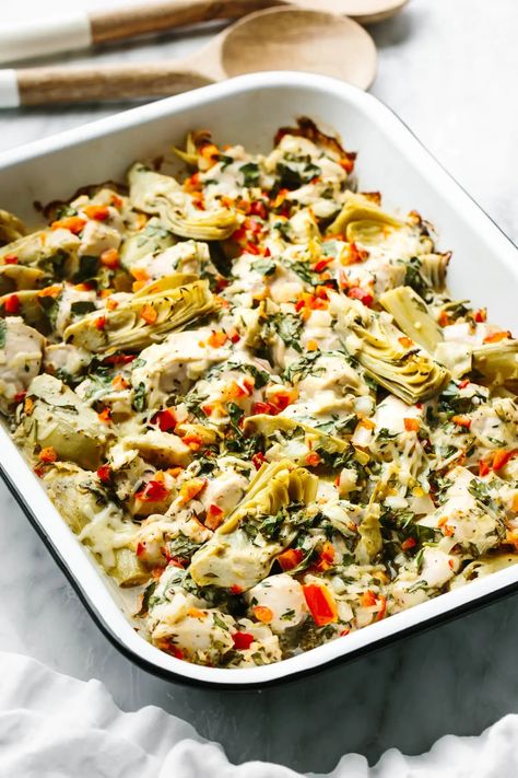 This spinach artichoke chicken bake is savory, cozy, and layered with loads of chicken and veggies for the perfect all-in-one meal prep dish. Spinach Artichoke Chicken Bake, Spinach Artichoke Chicken Orzo Bake, Chicken Artichoke Bake, Pesto Spinach Artichoke Chicken Bake, Chicken Artichoke Recipes, Spinach And Artichoke Casserole With Chicken And Cauliflower Rice, Chicken And Artichoke Casserole Eating Well, Healthy Chicken Casserole, Spinach Artichoke Chicken