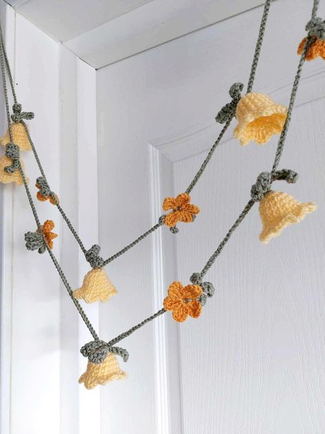 Delicate handmade garland, a lovely welcoming  for spring, Easter, summer, baby's room, Mother's Day gift, housewarming gift... Hang it in any place, and for sure will bring happiness and joy! It is hand crocheted by me, from acrylic yarn. It has bell flowers and small flowers with leaves. Plenty of chain at each end for hanging. Color choices in the drop down menu: (1) yellow bell flowers, saffron small flowers, olive green leaves.                                                                       (2) white bell flowers, powder pink small flowers, green leaves. Bell flower is about 4 cm  (1 1/2 inch). I have different lengths in the menu, and if you need something different just message me, and I will be happy to help. More garlands: https://www.etsy.com/shop/ChicInteriorsPlace Thank y Crochet Nursery Garland, Cute Crochet Wall Decor, Crochet Tulip Garland, Crochet Lily Of The Valley Garland, Small Green Crochet Projects, Home Crochet Decor, Crochet Welcome Sign, Crochet Ceiling Hanging, Crochet Living Room Decor