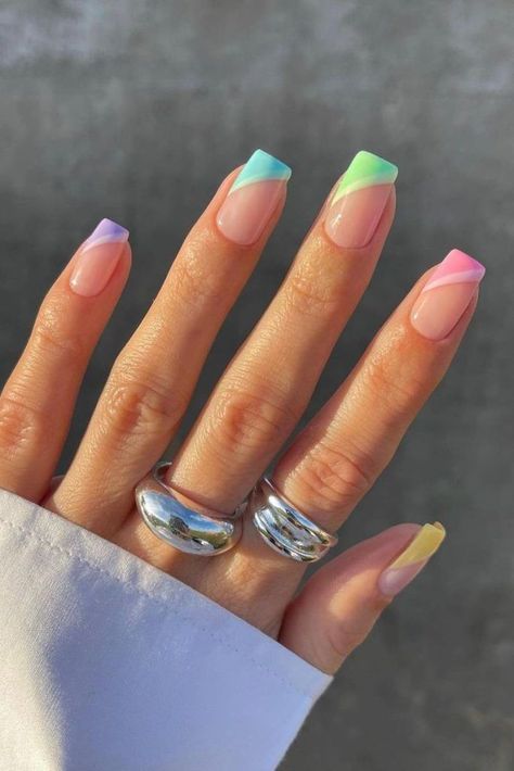 Take your nail game up a notch with this pastel gradient style. Although the gradient might be hard to spot from far away, it’ll serve as a surprise detail that earns you endless compliments. Plus, the rainbow hues add the perfect pop of color. Pastel Colour Tips Nails, Hard Gel Nails Design Summer, Nail Art Pastel Colors, Mallorca Nails, Multi Colour Nails, Rainbow Tip Nails, Nails Acrylic Pastel, Pastel Rainbow Nails, Pastel Nail Ideas