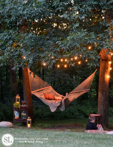 Is there anything more soothing than a hammock gently swinging under string lights? This easy-to-pull-off setup is guaranteed to be your favorite spot to relax. Get the tutorial at By Stephanie Lynn.   - CountryLiving.com Backyard Hammock, Easy Backyard, Backyard Lighting, Backyard Spaces, Have Inspiration, Beautiful Backyards, Dream Backyard, Backyard Fun, Outdoor Oasis