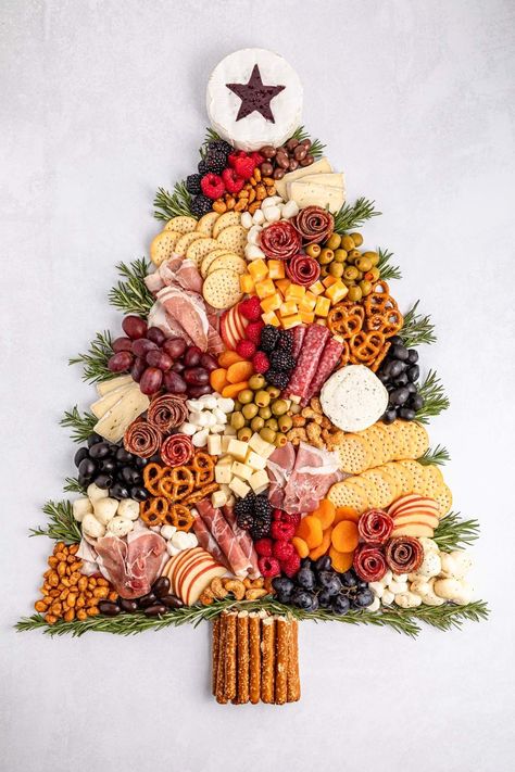 Charcuterie boards have taken the spotlight recently, and with the festive season approaching, why not create a charming Christmas tree charcuterie board for your holiday gathering? This playful and festive board can be crafted to any size you want. Picture an assortment of deliciously sliced meats and cheeses, paired with creamy cheeses, olives, crunchy pretzel sticks, and a colorful mix of fresh fruits and veggies. And you can feel free to add any other treats that tickle your festive fancy!