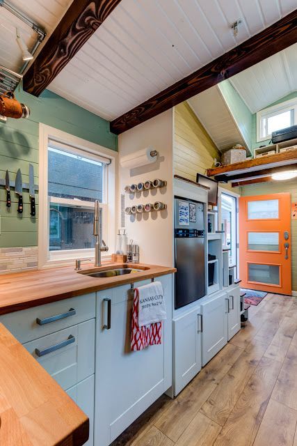 The Wanderlust is a 170-sq-ft tiny house on wheels, currently traveling the U.S. Its owners purchased the 20' x 8.5' home from Tumbleweed Tiny House Co. as a barn raiser home. | Tiny Homes Tiny Home Color Scheme, 20 Ft Tiny House, Tumbleweed Tiny Homes, Tiny House Towns, Tiny House Company, Building A Tiny House, Tiny House Inspiration, Tiny House Kitchen, Small Space Kitchen