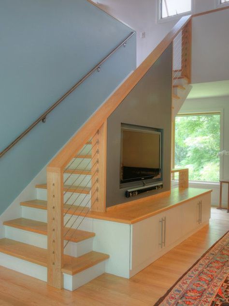 I like how this uses solid wall to support the TV and a more open railing everywhere else. Living Room Under Stairs, Staircase In Living Room, Room Under Stairs, تحت الدرج, Step Shelves, Modern Traditional Home, Stairs Design Interior, Stairs In Living Room, Stair Wall