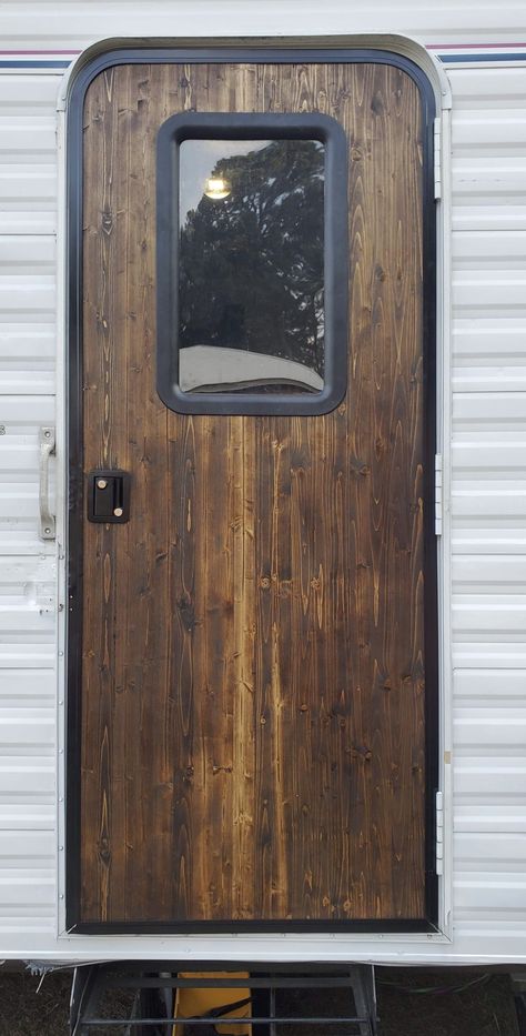 Rebuilt door from edge glued wood 1”x16”x72”. New window trim and door handle approx. $200.00 rebuild. Rv Wood Window Trim, Camper With Wood Cabinets, Camper Door Remodel, Rv Door Remodel, Camper Dog Door, Rustic Camper Renovation, Diy Camper Door Replacement, Exterior Camper Door Makeover, Rv Door Ideas