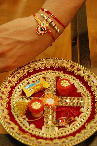 Rakhi    A Hindu tradition where a sister ties the jeweled string bracelets around the brothers wrist, praying for his health and prosperity. In return, the brother promises to take care of his sister, as a father would. Indian Holidays, Happy Raksha Bandhan Wishes, Raksha Bandhan Images, Rakhi Special, Raksha Bandhan Wishes, Thali Decoration Ideas, Pooja Thali, Amazing India, String Bracelets