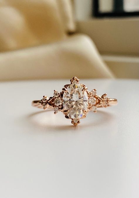 Enchanted moissanite 14k rose gold engagement ring gold. Dela whimsical filigree design by EidelPrecios. This engagement ring features an 1ct white moissanite, 5x7mm, sparkling and clean. It is set our new Dela fantasy inspired setting, 14k rose Gold, 12 white moissanites on the sides. This ring would make a beautiful unique engagement ring or promise ring as well as anniversary gift. It comes in a gorgeous rose wood ring box, ready to present. Details: Center stone: moissanite  approx. 1ct (5x7 Engagement Rings Fairy, Ethereal Engagement Ring, Fairytale Wedding Ring, Engagement Ring Gold, Pretty Engagement Rings, Moissanite Engagement Ring Rose Gold, Fantasy Ring, Green Sapphire Ring, Ring Inspo