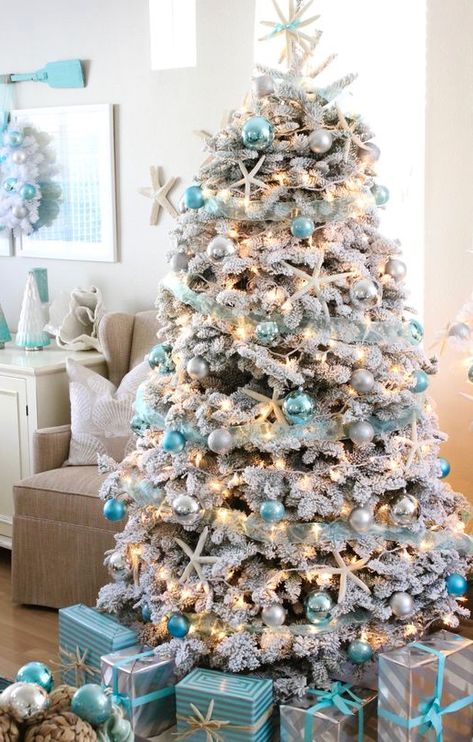 Snowy Flocked Coastal Christmas Tree Ideas with Blue Ornaments. Shop this Blue and White Coastal Christmas Look. Featured on Completely Coastal. Blue And White Christmas, Coastal Christmas Tree, Happy Christmas Eve, Blue Christmas Decor, Coastal Christmas Decor, Beachy Christmas, Blue Christmas Tree, A White Christmas, Gold Christmas Decorations