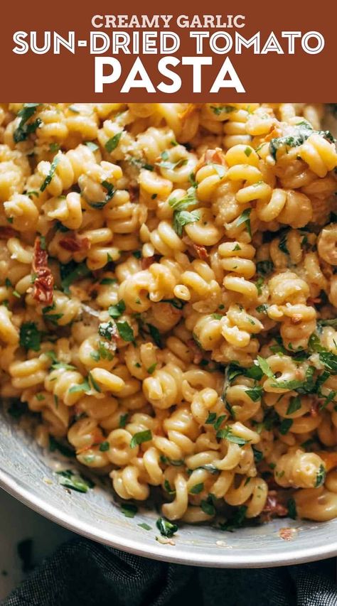 Creamy Garlic Sun-Dried Tomato Pasta! You are thisclose to enjoying Creamy Garlic Sun-Dried Tomato Pasta! Garlicky spirali noodles and tender sun-dried tomatoes in a creamy, luscious sauce with a heavy dusting of Parmesan cheese. #pasta #sundriedtomatoes #easyrecipe Creamy Garlic Sundried Tomato Pasta, Healthy Sun Dried Tomato Pasta, Pesto Sun Dried Tomato Pasta, Feta Sundried Tomato Pasta, Recipes Using Sun Dried Tomatoes In Oil, Curly Pasta Recipes, Creative Pasta Dishes, Pasta With Sun Dried Tomatoes Recipes, Healthy Tomato Pasta