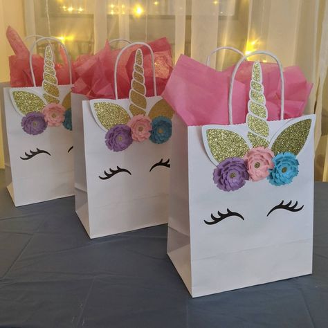 "This birthday party package accommodates 12 guests. You will receive 12 invitations, 12 goodie/favor bags, 12 cupcake toppers, and one full banner including the birthday child's name. By ordering as a full package you receive a savings of $25 approximately. If you have a larger or smaller party you can order additional invitations, good bags, and cupcake toppers in the links below or you can message me so that I can create a listing to accommodate your specific party.  Invitations: The invitati Unicorn Theme Goodie Bags, Diy Unicorn Birthday Party, Unicorn Pool Party, Unicorn Barbie, Rainbow Unicorn Birthday Party, Unicorn Birthday Party Decorations, Unicorn Decor, Rainbow Unicorn Party, Unicorn Themed Birthday Party