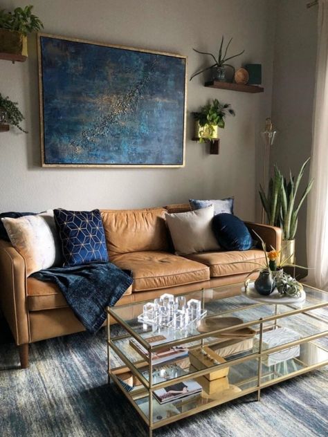 FALLing hard with all these Fall tones.⁠ ⁠Styles by @westelm ⁠#twelveriversrealty #livingroom #westelm #houseplants #blue #gold⁠ Brown Leather Couch Living Room Decor Navy Blue, Navy Blue And Cognac Living Room, Brown And Navy Living Room, Navy And Brown Living Room, Tan And Blue Living Room, Tan Couch Living Room Ideas, Blue And Tan Living Room, Blue And Brown Living Room, Brown Leather Couch Living Room