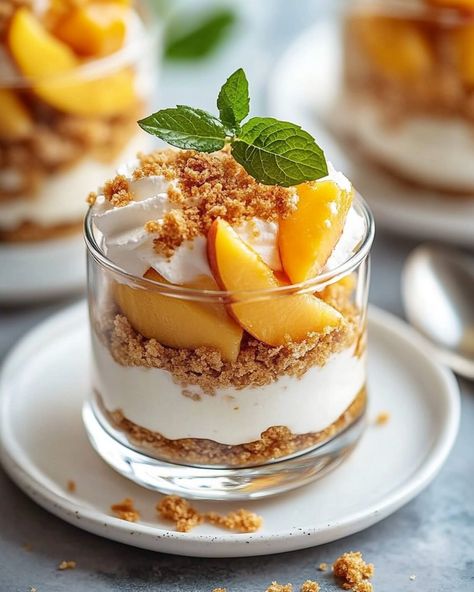 Peach Cobbler Cheesecake Parfaits 🍰🍑 Indulge in the delightful layers of Peach Cobbler Cheesecake Parfaits! This no-bake dessert combines creamy cheesecake flavors with sweet peaches and crunchy graham cracker crumbs, making it a refreshing treat perfect for summer or any occasion. Quick to assemble and visually stunning, these parfaits are sure to impress! #PeachCobbler #CheesecakeParfait #DessertDelight Ingredients: • ¼ cup unsalted butter, melted • 2 cups fresh or canned peaches, diced • ½... Cheesecake Flavors, Peach Cobbler Cheesecake, Cheesecake Parfaits, Canned Peaches, Bake Dessert, Creamy Cheesecake, Sweet Peach, Peach Cobbler, Graham Cracker Crumbs