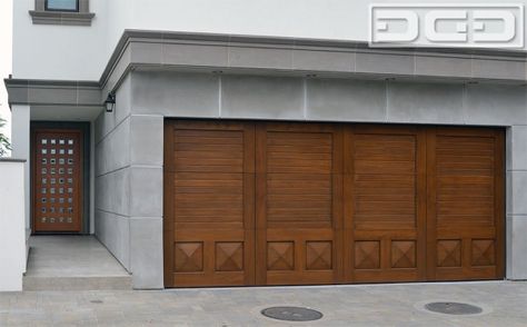 Modern Mediterranean Garage Door Design with beautiful solid mahogany pyramid panels and upper louvered design. Get prices on our custom wood garage doors at: (855) 343-DOOR Mediterranean Garage, Custom Wood Garage Doors, Automatic Gates Driveways, Custom Garage Doors, Wood Garage, Door Projects, Luxury Residence, Wood Garage Doors, Garage Door Design