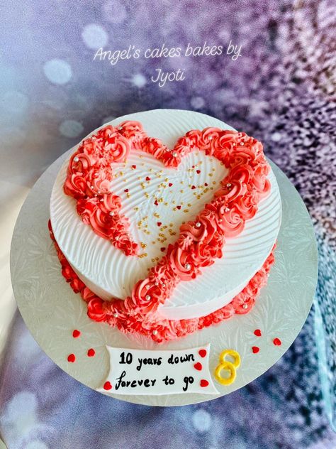 A simple and elegant 10th wedding anniversary cake with flowers in the shape of a heart 💑❤️🌸 Eggless orange fanta flavored cake layered with fresh cream frosting 🍊🎂😋 #Eggless #orangefantacake #freshcream #whippedcream #10thAnniversarycake #freshcream #AngelsCakesBakesbyJyoti 1 Kg Anniversary Cake Design, Anniversary Heart Cake Designs, Heart Shaped Anniversary Cakes, 10 Year Anniversary Cake Ideas, Cute Anniversary Cake Ideas Simple, Heart Shape Cake Designs For Anniversary, Anniversary Simple Cake, Easy Anniversary Cake, 10 Anniversary Cake