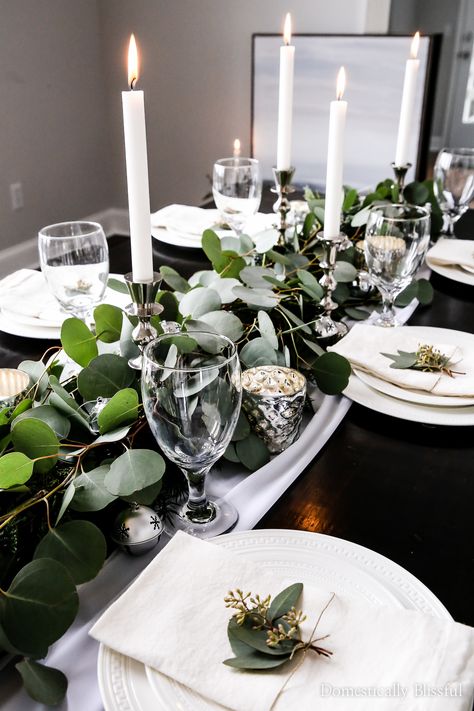 This Silver Bell Tablescape is perfect for the holiday season, with 24 silver bells, tall silver candlesticks, & mercury candle holders tucked into silver dollar eucalyptus that lay upon a white table runner you are sure to have a beautiful holiday party! Mercury Candle Holders, White Table Runner, Dollar Eucalyptus, Silver Christmas Decorations, Christmas Dinner Table, Spring Centerpiece, Tablescape Ideas, Silver Dollar Eucalyptus, Christmas Tablescape